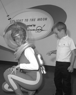 Curious boy looking at a female astronaut